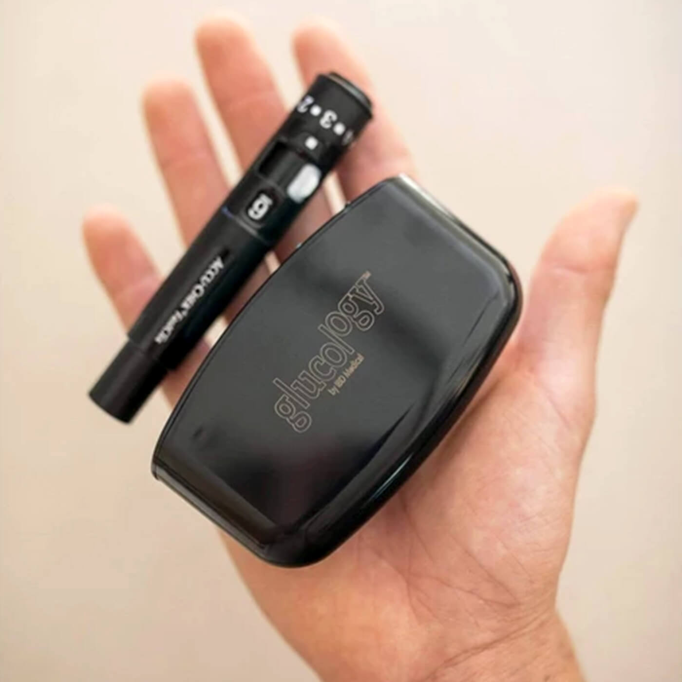 Hand Holding The Glucology Pen Needle Pocket Container (lancing device not included).